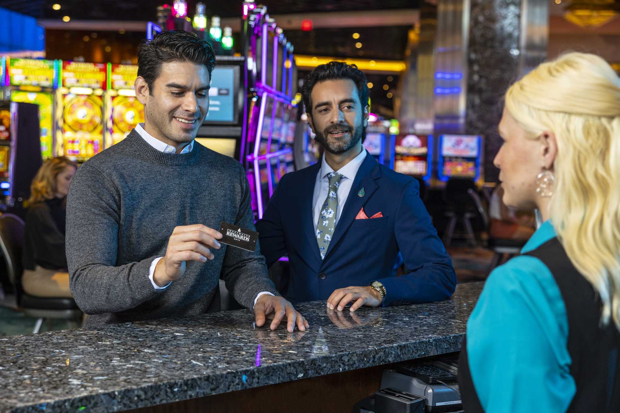 A man receiving a Sweetwater Rewards card at Jamul Casino Resort.